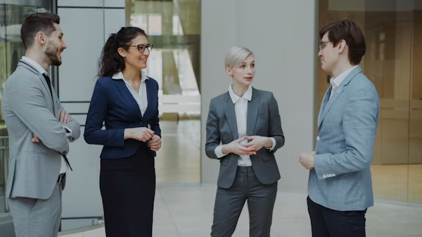 Business professionals discussing a partnership in an office lobby