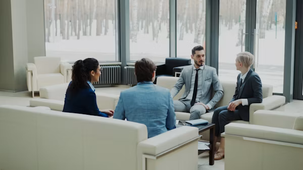 Team discussing editorial strategy in a modern office