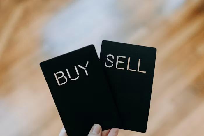 Hand holding buy and sell trading cards