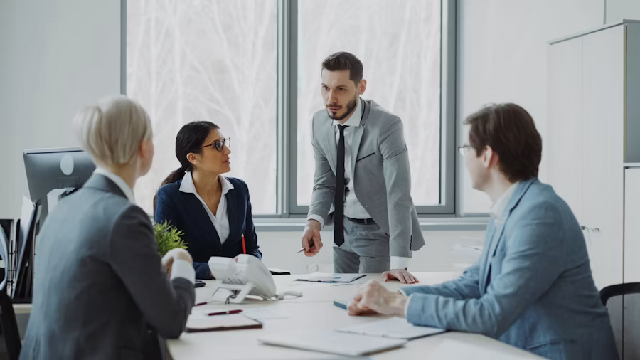 Analysts discussing economic data around a conference table